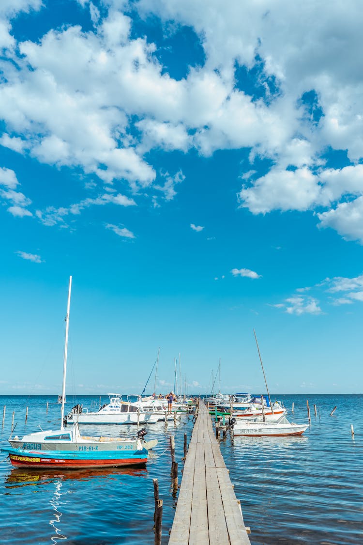 Photograph Of White Boats On A Dock