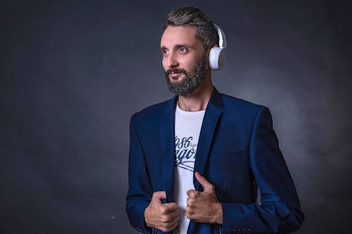 A Man in Blue Suit Wearing Headphones