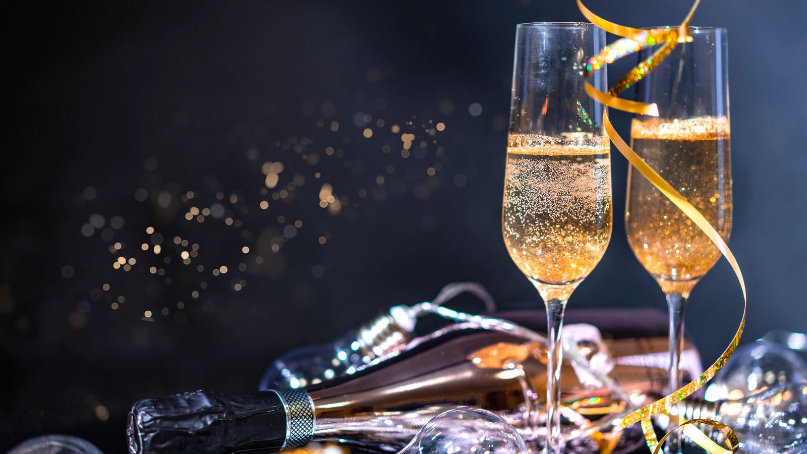 Glasses of champagne set out for a New Year celebration with festive decorations