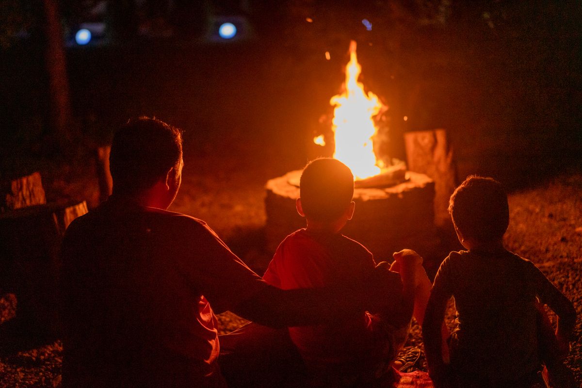 Family gathered around a campfire telling stories