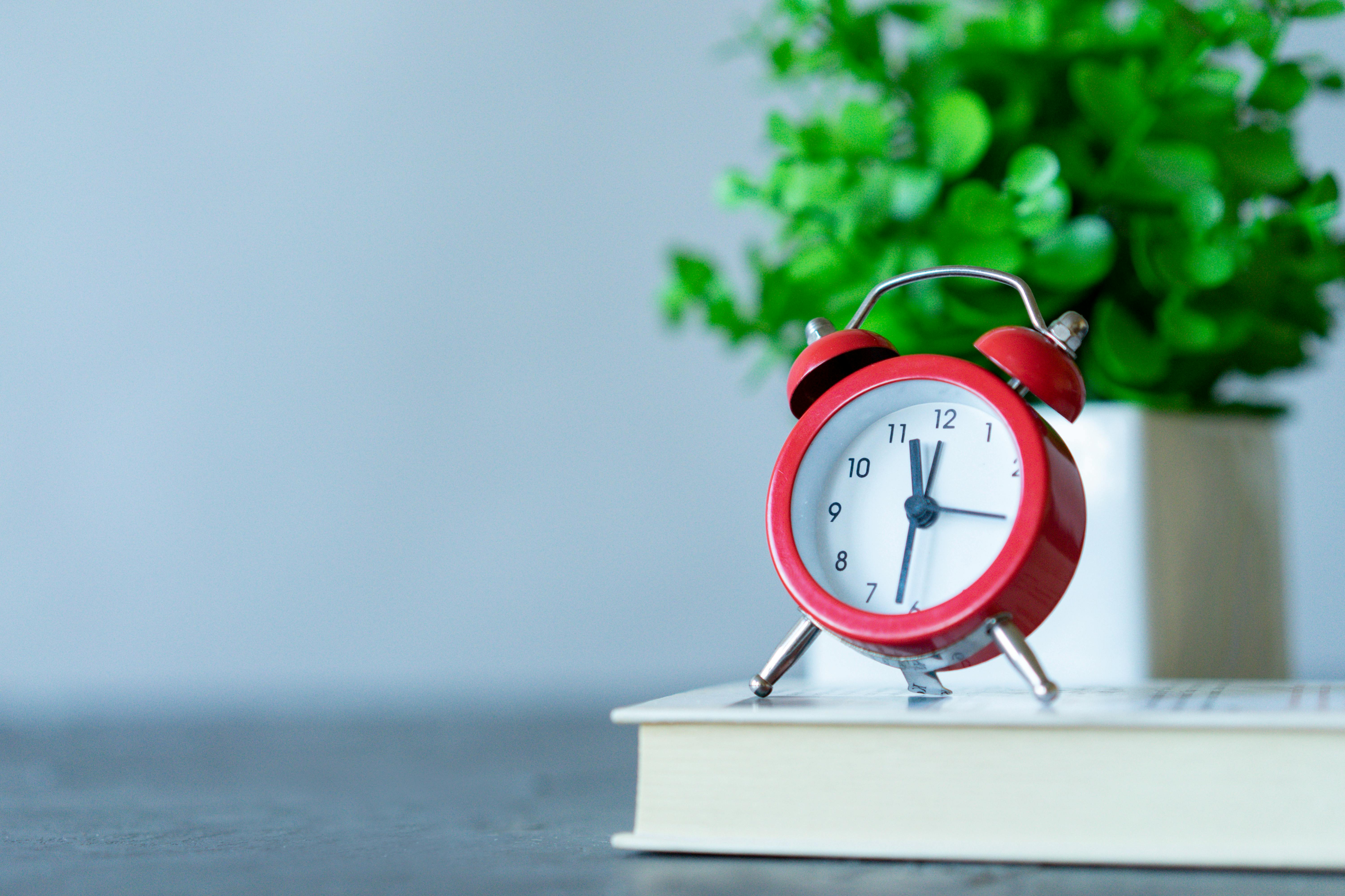 Red Alarm Clock on a Book