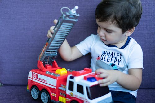 Boy Playing a Toy Truck