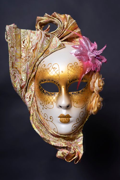 Free Elegant Venetian mask with gold and floral embellishments on a black background. Stock Photo