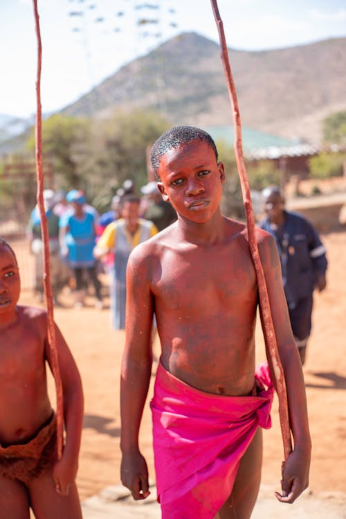 Shirtless Boys Holding a Stick