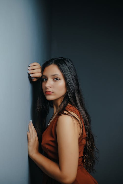 Brunette in Dress Leaning on Wall