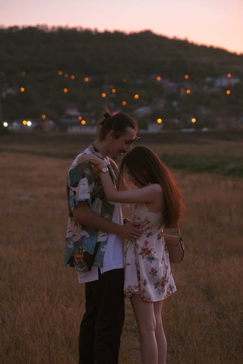 Romantic Couple Standing on Grass Field