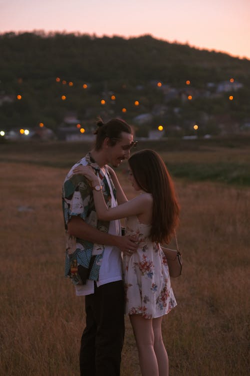 Romantic Couple Standing on Grass Field