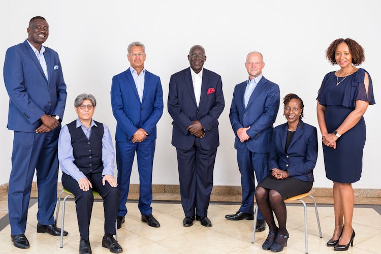 Smiling Team Of Businesspeople Posing Together In Office