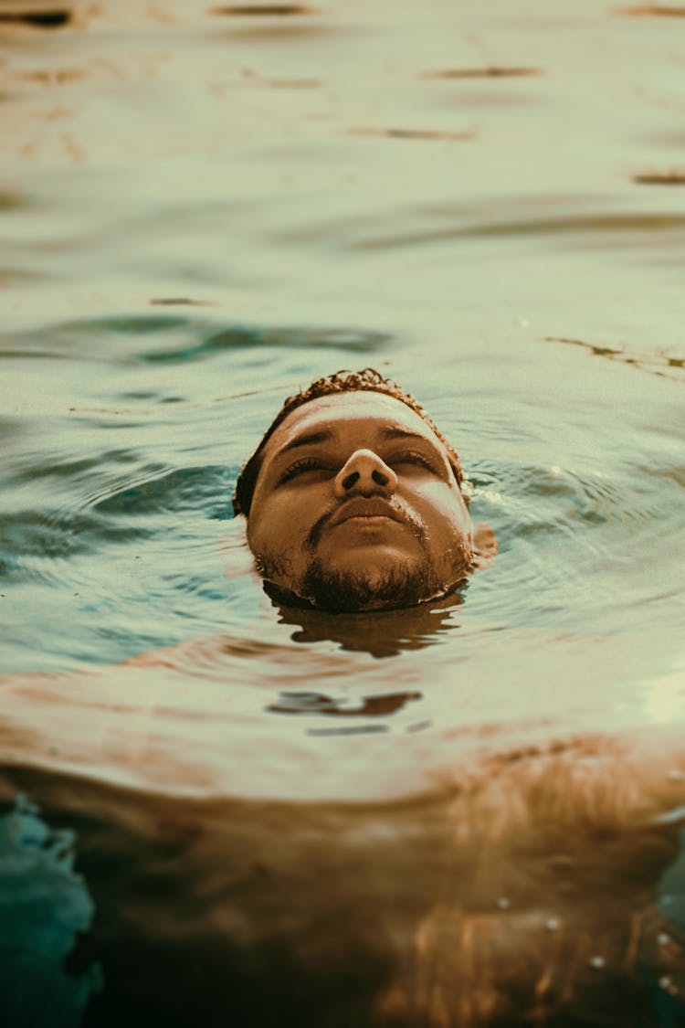 A Man Floating On Water