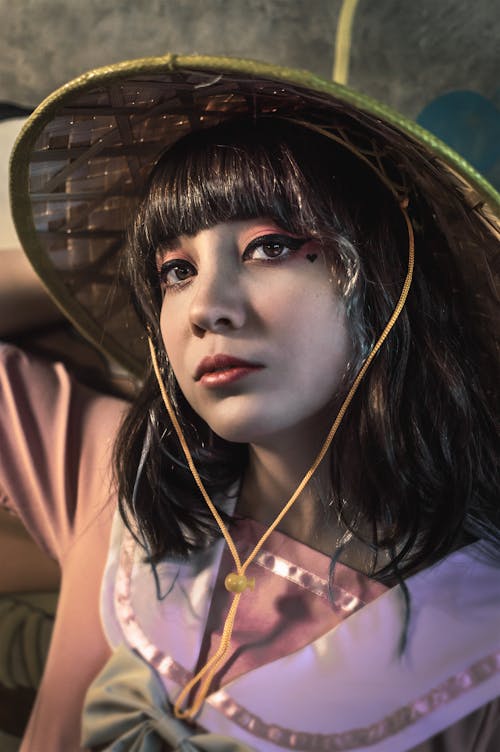 Woman Posing in Bamboo Hat and Pink Dress