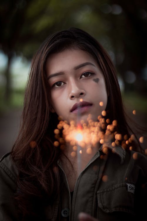 Free Woman Holding a Sparkler Stock Photo