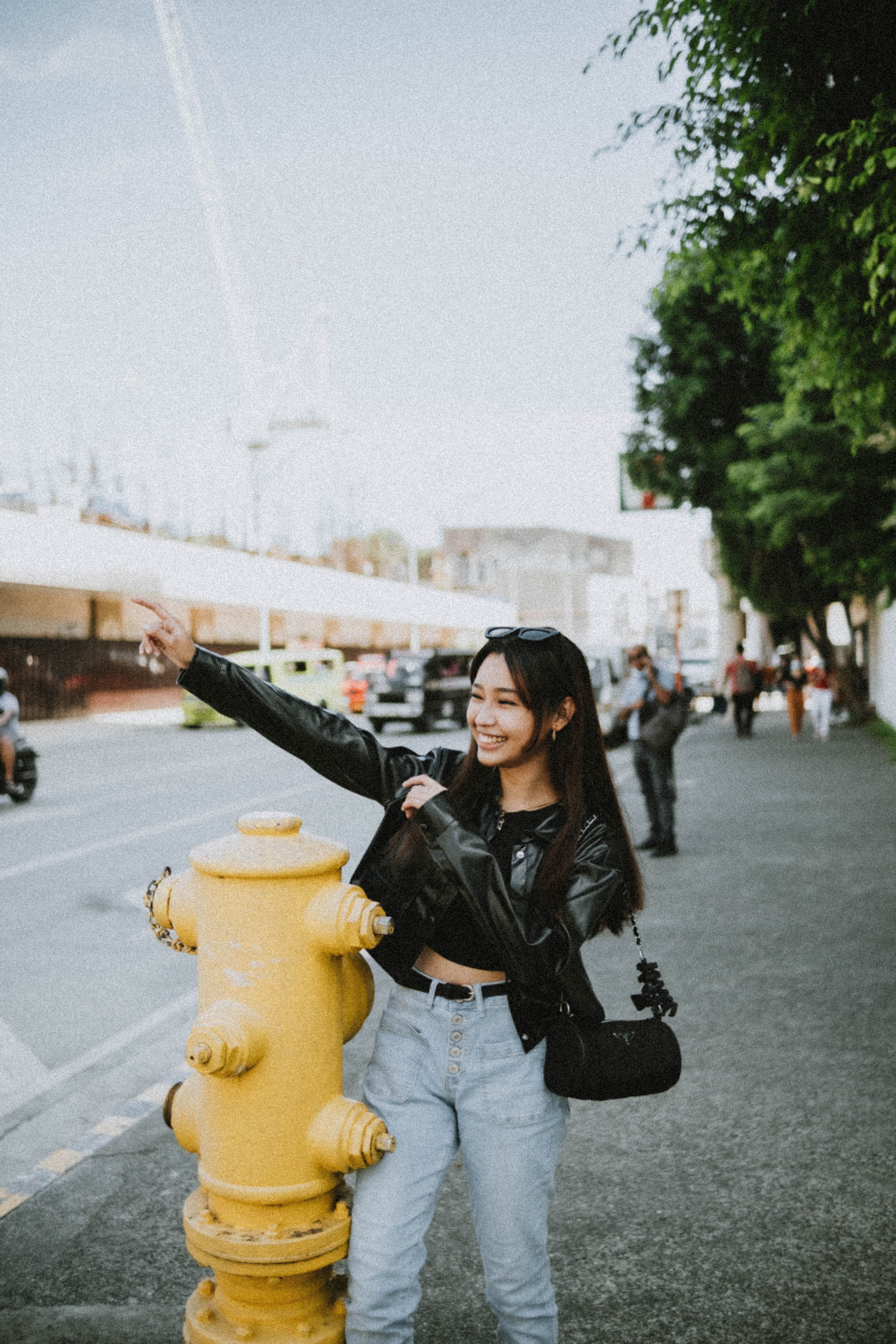 Woman in Black Leather Jacket and Denim Jeans Standing Beside a Yellow ...