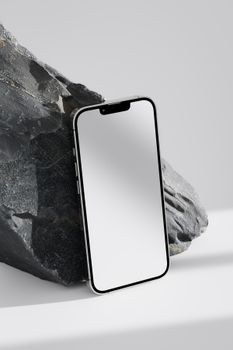 Close-up of a smartphone against a stone background, emphasizing modern design.