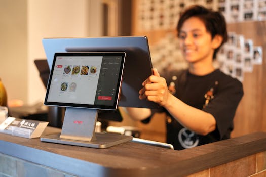 Smiling cashier using a touchscreen POS system in a modern retail environment.
