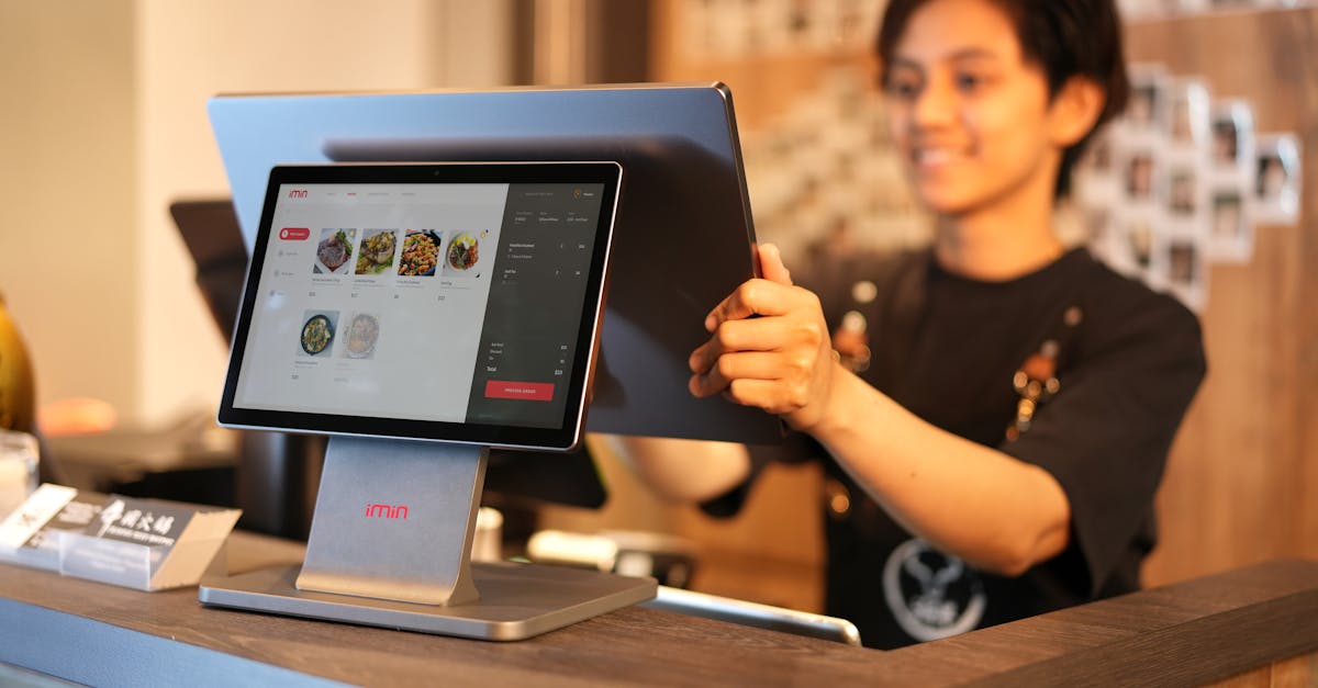Cashier Using Touchscreen · Free Stock Photo