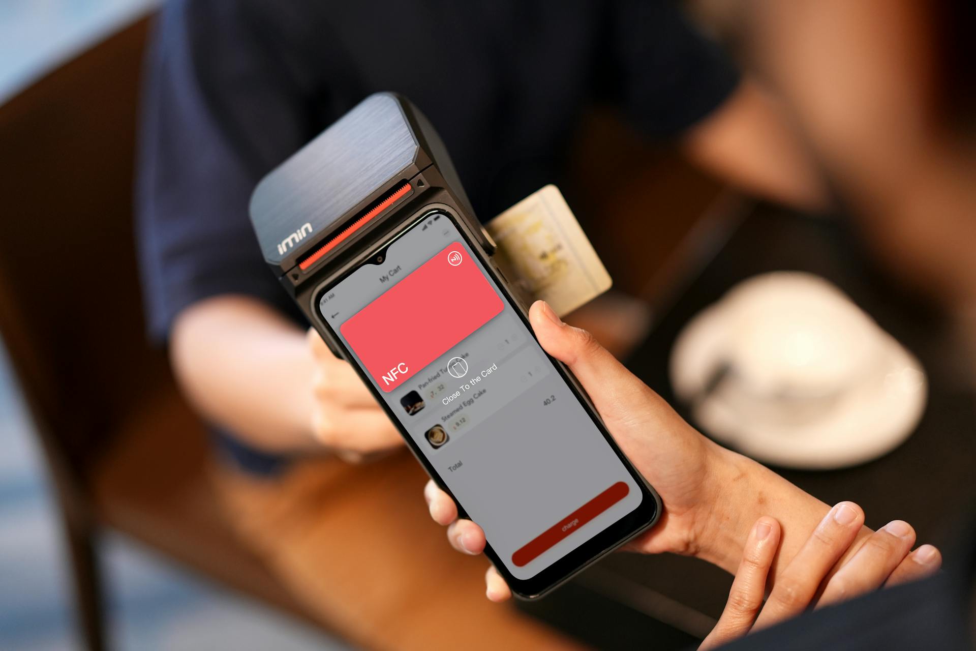 A Close-Up Shot of a Person Holding a Payment Terminal