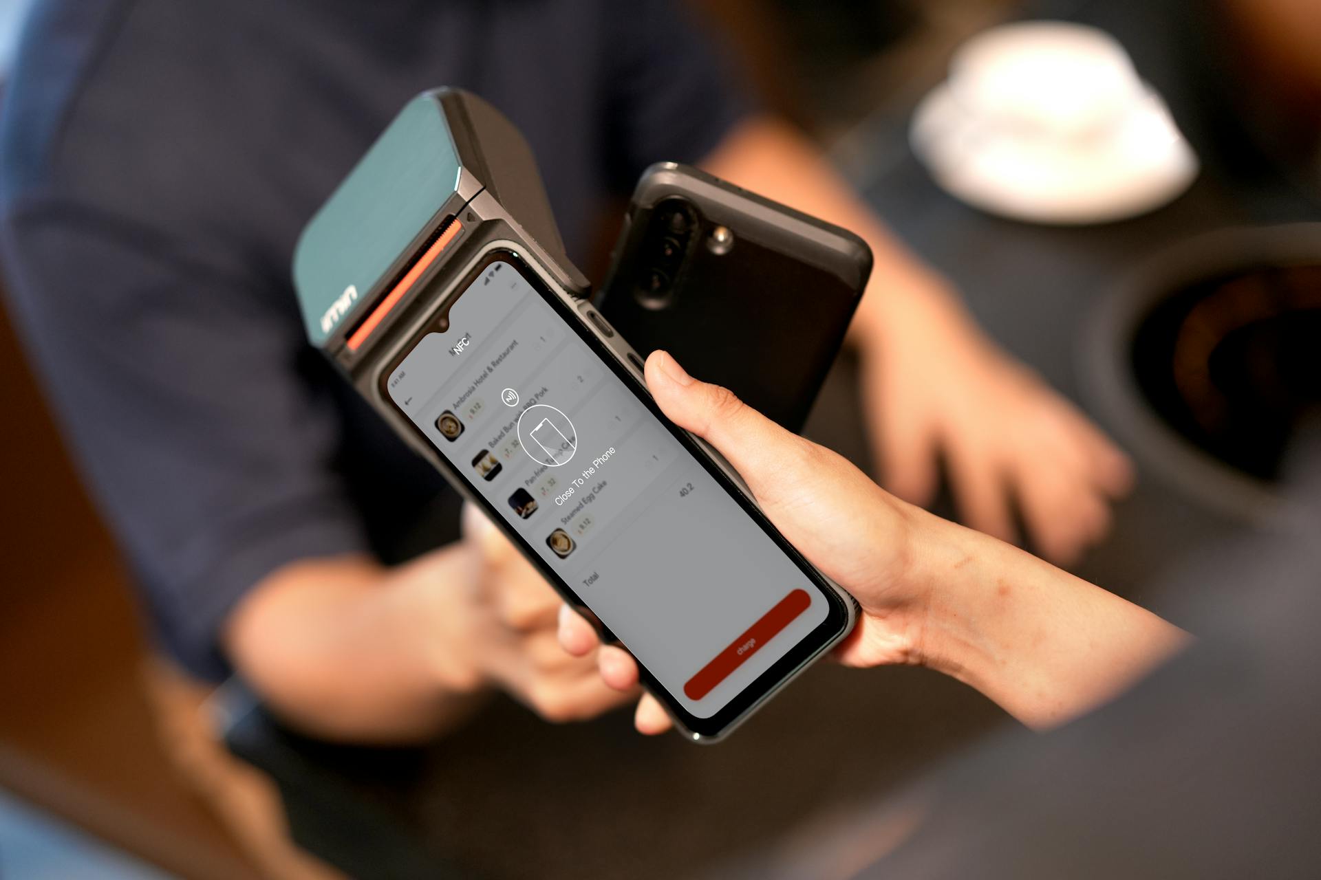 A  Person Holding a Payment Terminal