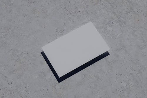 White Paper on Gray Concrete Ground
