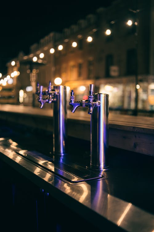 A Close-Up Shot of Silver Beer Taps