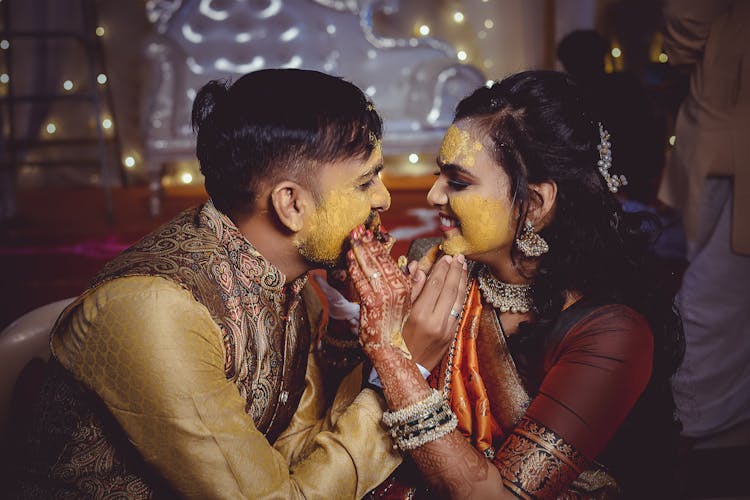 A Couple Doing The Haldi Ceremony In Their Wedding