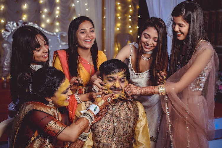 A Bride And Groom In A Haldi Ceremony