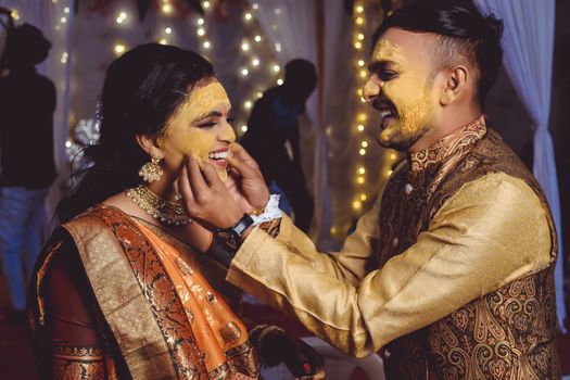 A Couple with Turmeric Paste on Their Faces