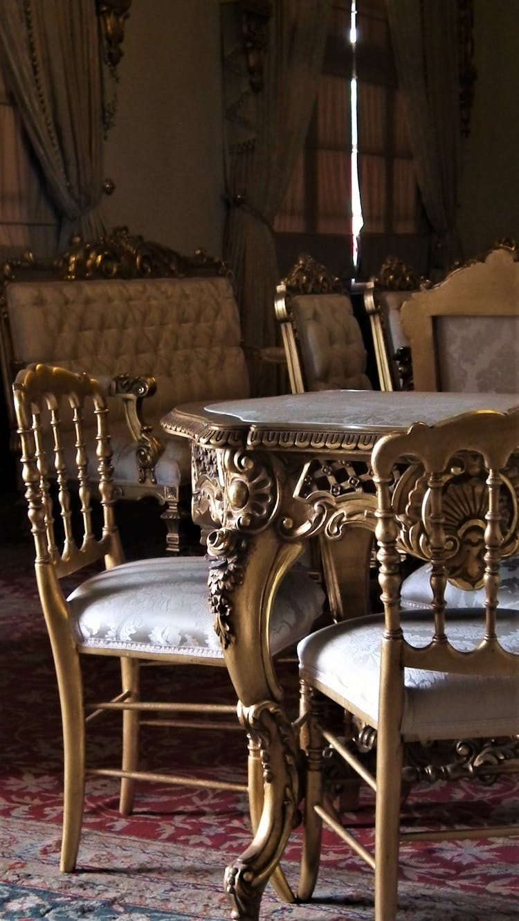 Antique Ornate Design Of A Dining Table And Chairs