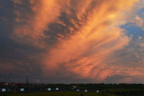 Free Vivid orange sunset clouds over a serene landscape, capturing nature's beauty. Stock Photo