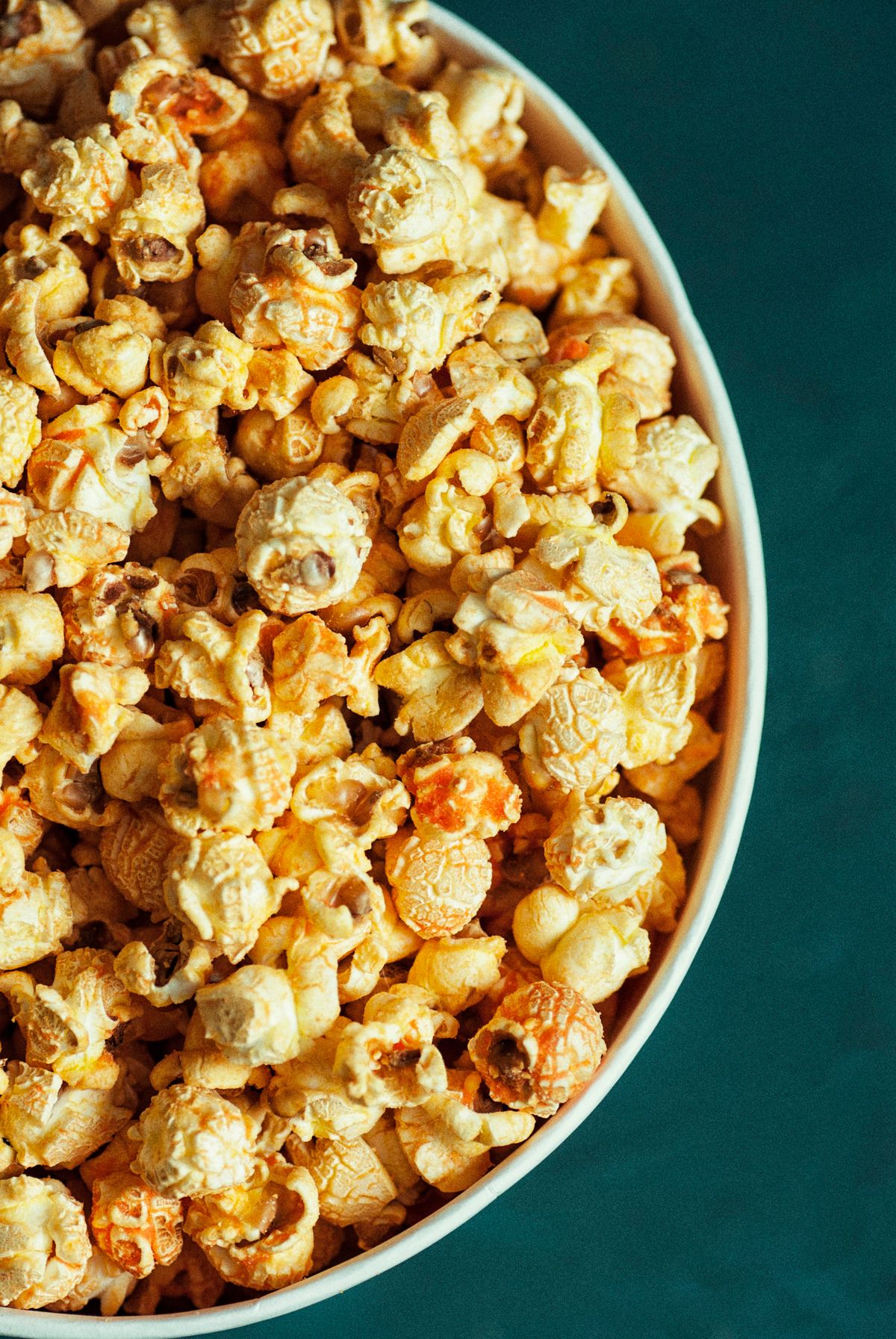 A bowl of real popcorn photographed from above in a food styling scene