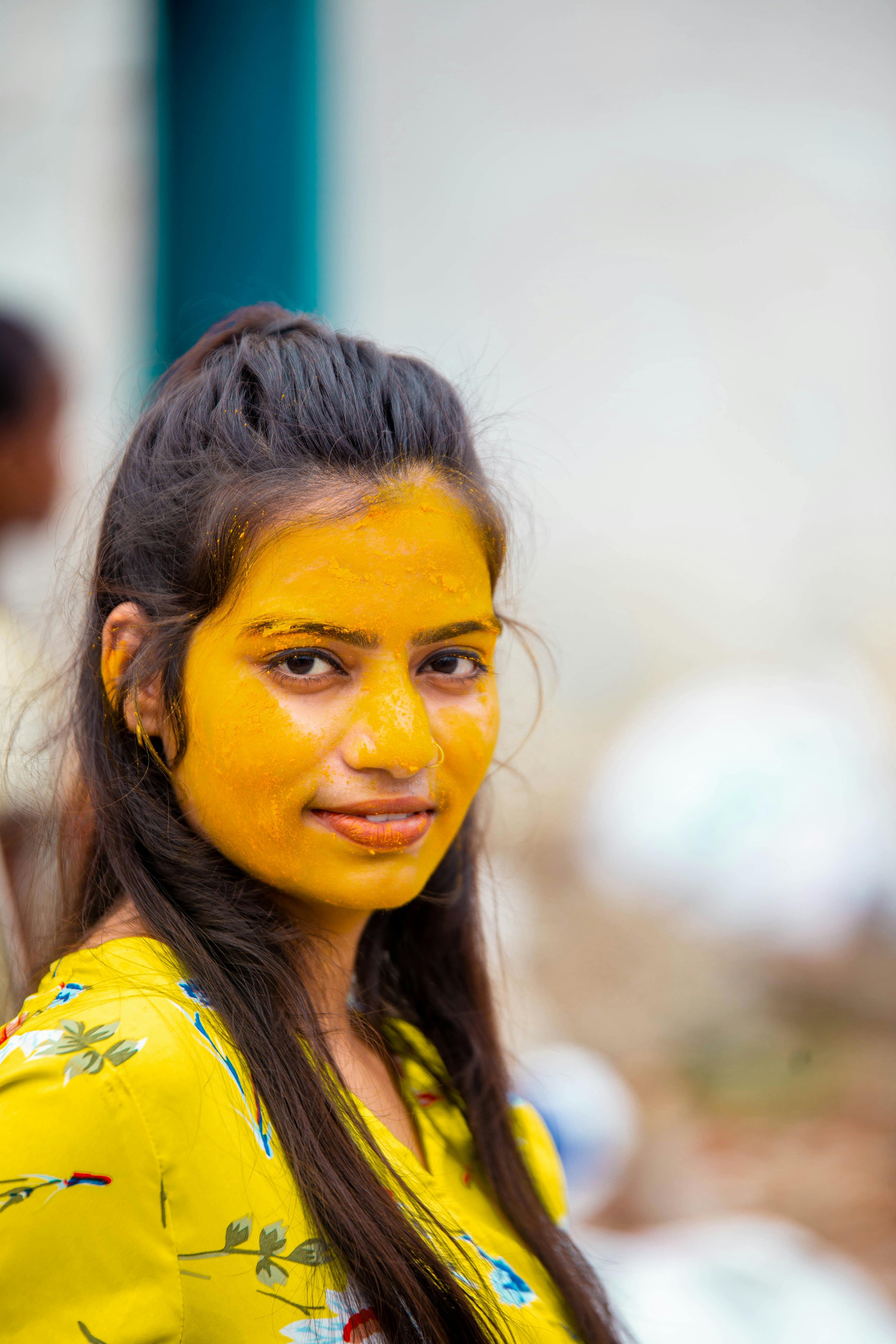 A Woman with Yellow Paint Powder on Face · Free Stock Photo