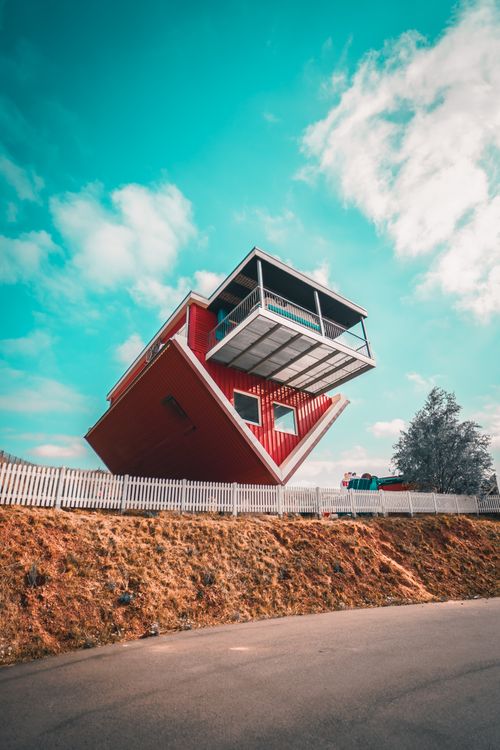 Free Unique architectural landmark of an upside down house under a clear blue sky, creating a striking visual. Stock Photo