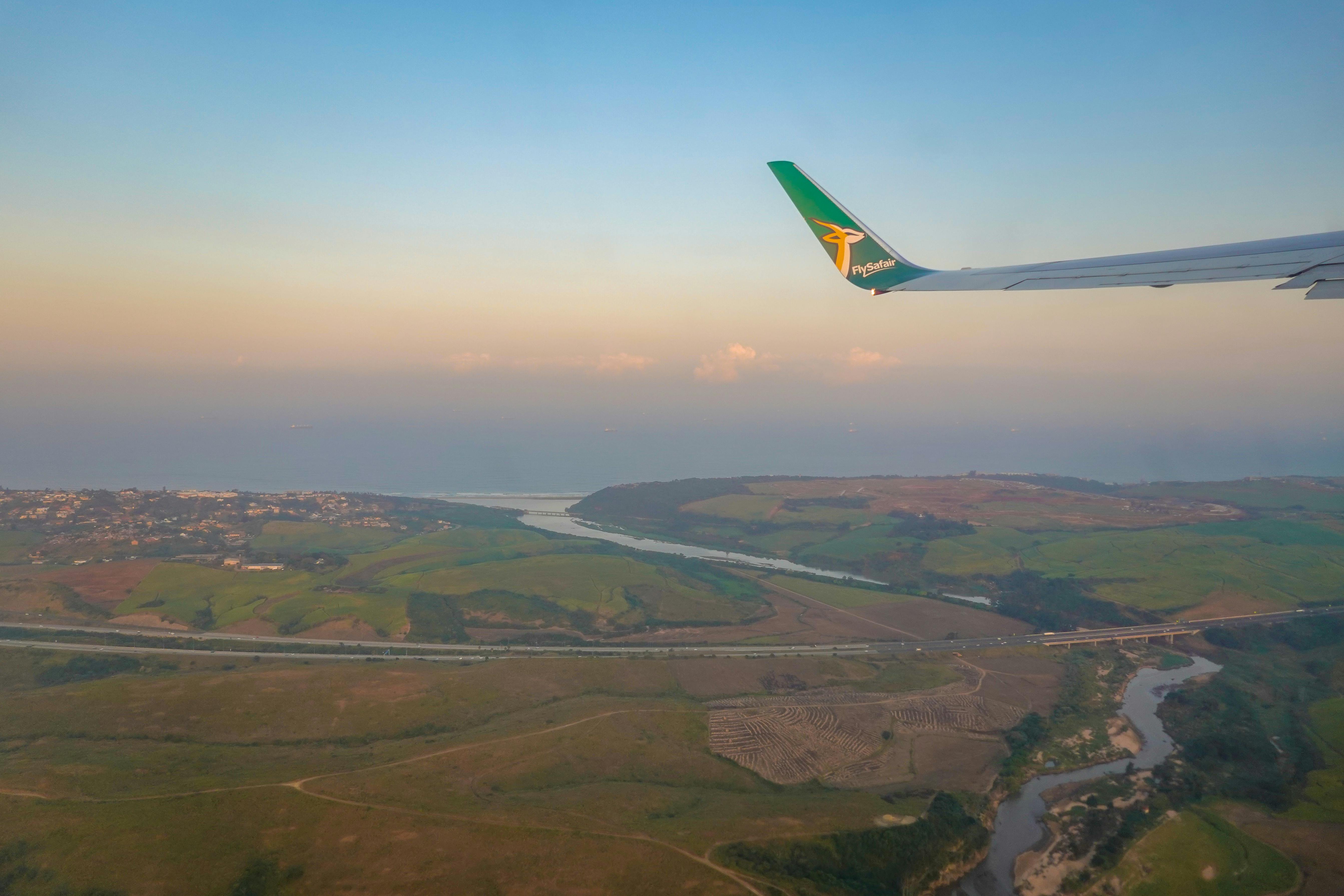 Airplane wing view from daytime flight window