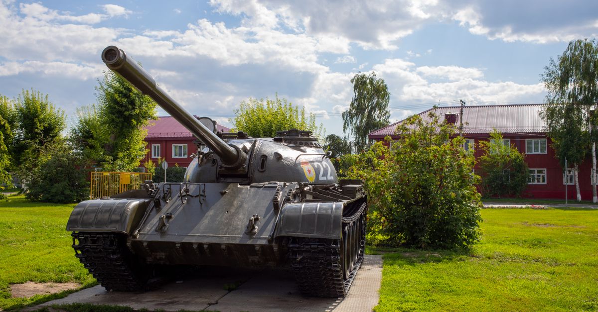 Photo by Михаил Крамор Classic military tank on display in a sunny park setting, showcasing history.