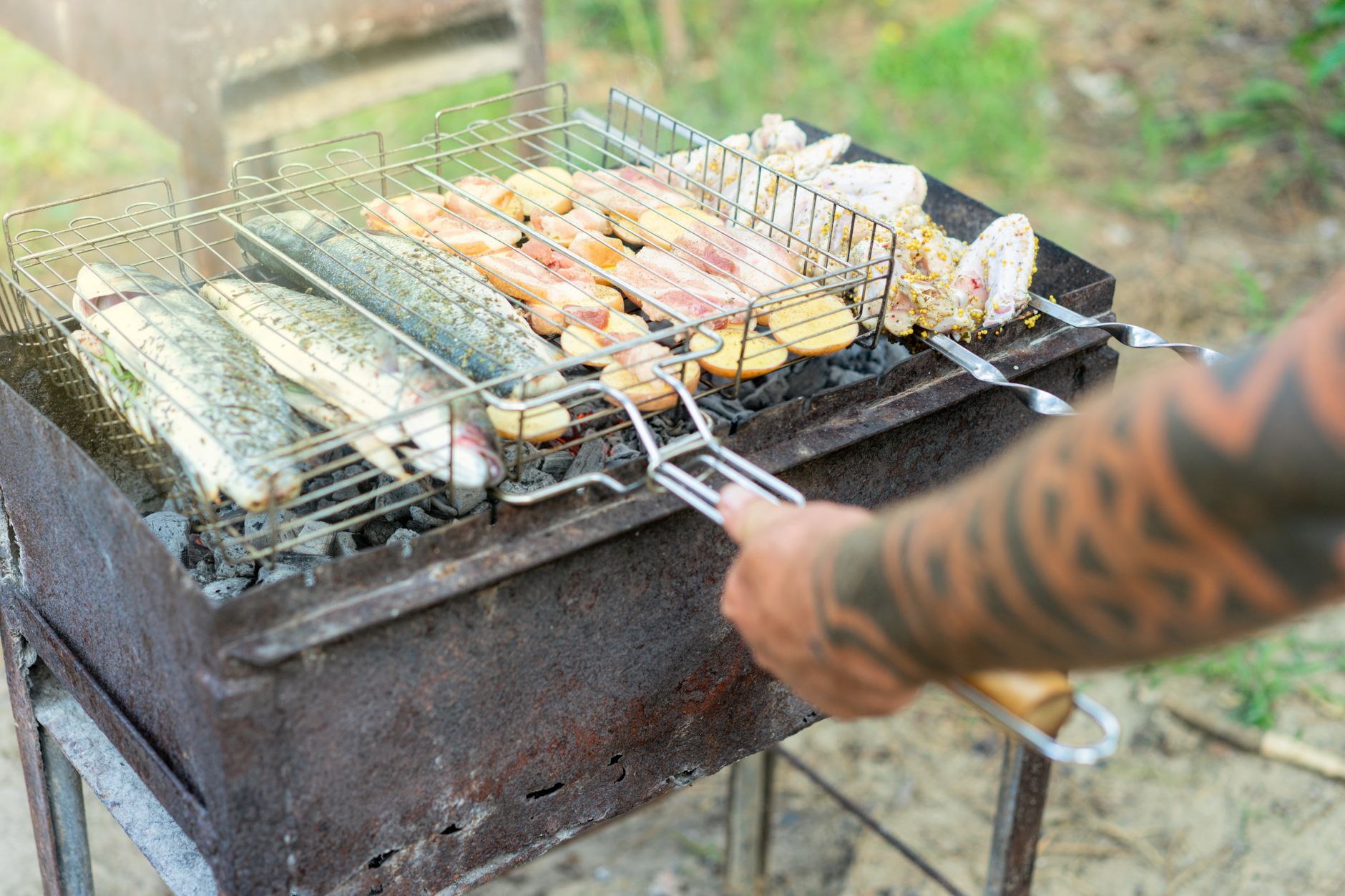 Close-up of seasoned fish filet in grilling basket ready to cook