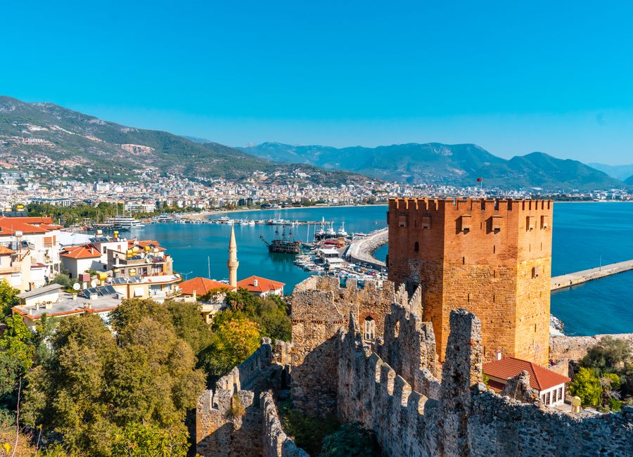 Stunning view of Kizil Kule and Alanya harbor in Antalya, Turkey with vibrant city and sea landscape.