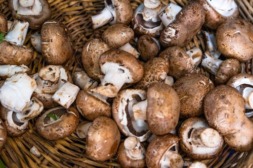 Brown mushrooms in a woven basket