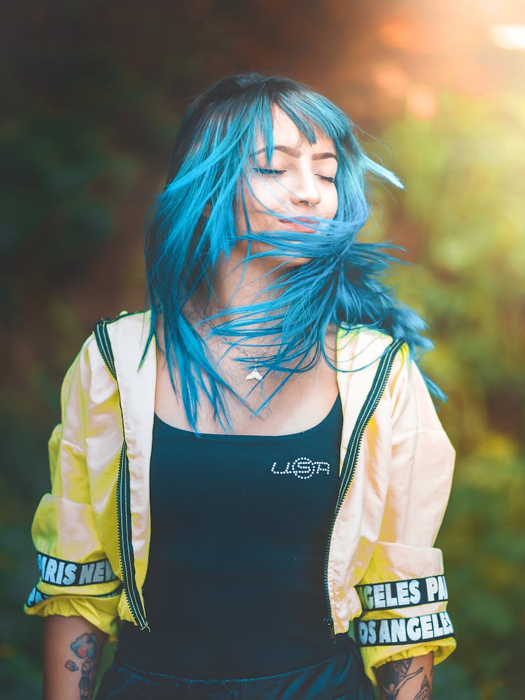 A Woman In Yellow Jacket Shaking Her Hair