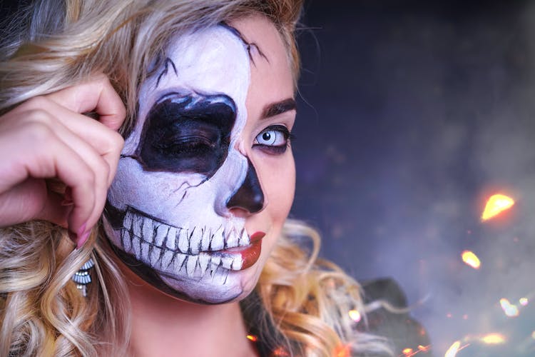 Woman In Halloween Half Skull Makeup 