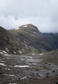 Peaceful mountain scene in Tirol, Austria, showcasing a crisp, natural setting under a cloudy sky.