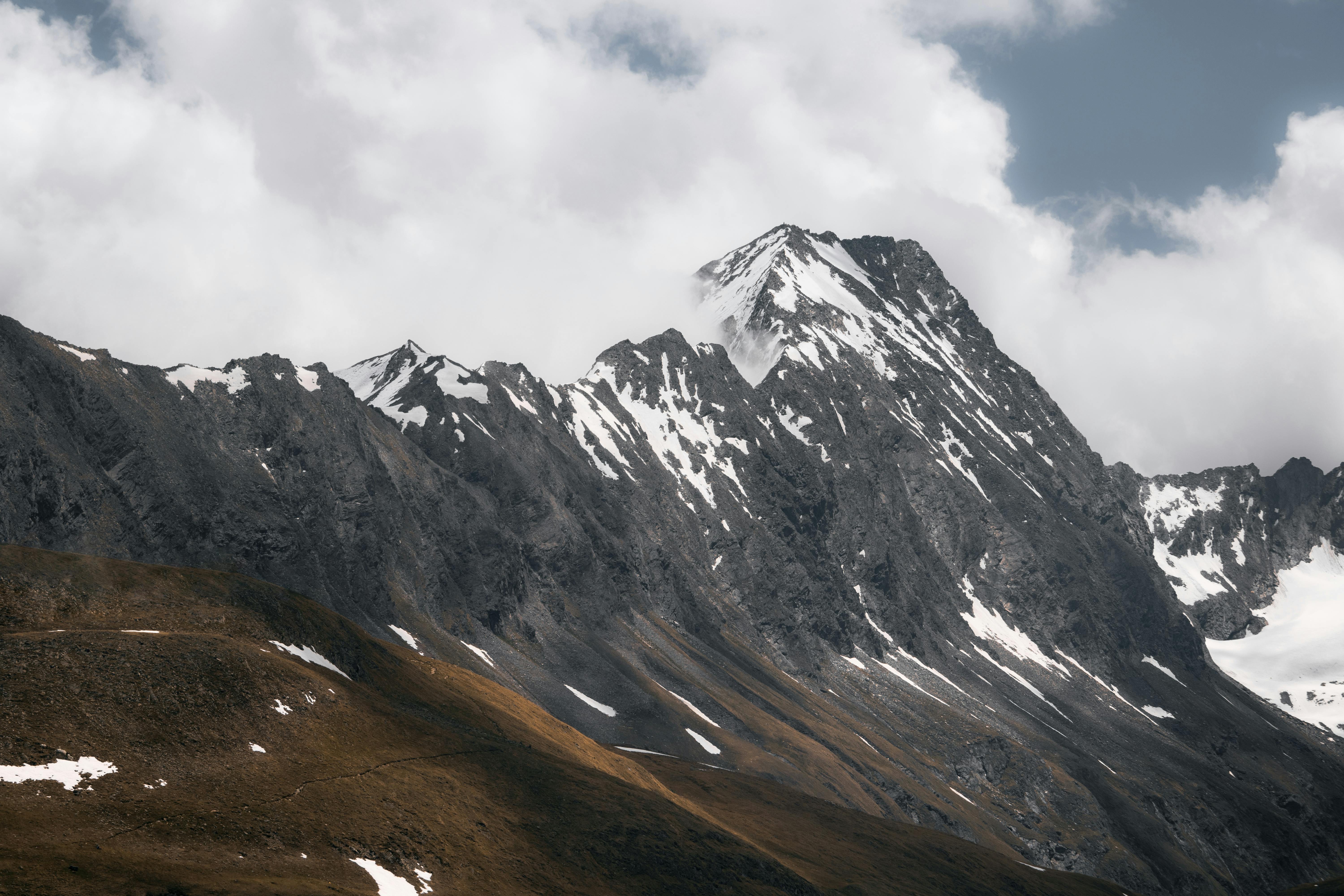 gray and white mountain under white clouds