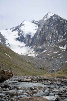 Stunning view of snow-capped mountain peaks and rocky terrain in Tirol, Austria captured in daylight.