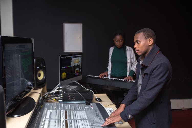 Man And Woman Working In The Music Studio