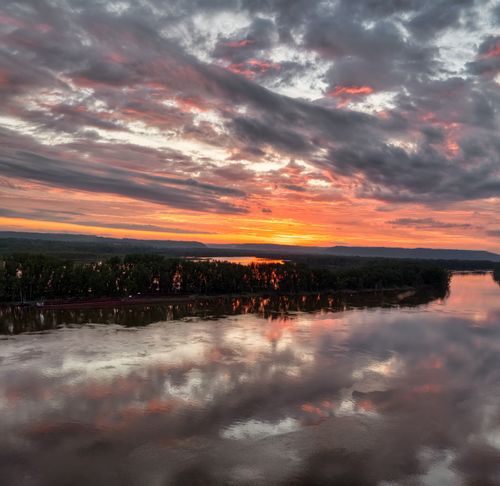 Free Stunning sunset reflecting over the Mississippi River near Red Wing, MN, with dramatic clouds. Stock Photo