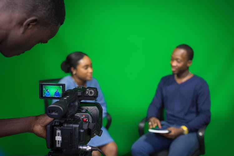 Man Filming An Interview Between An Man And A Woman