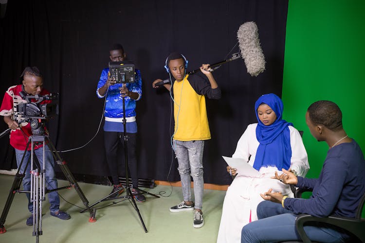 People Shooting In A Studio