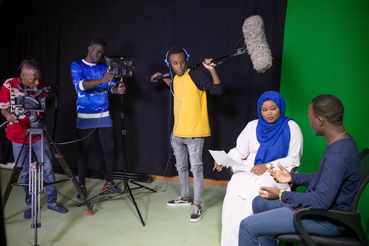 People Shooting In A Studio