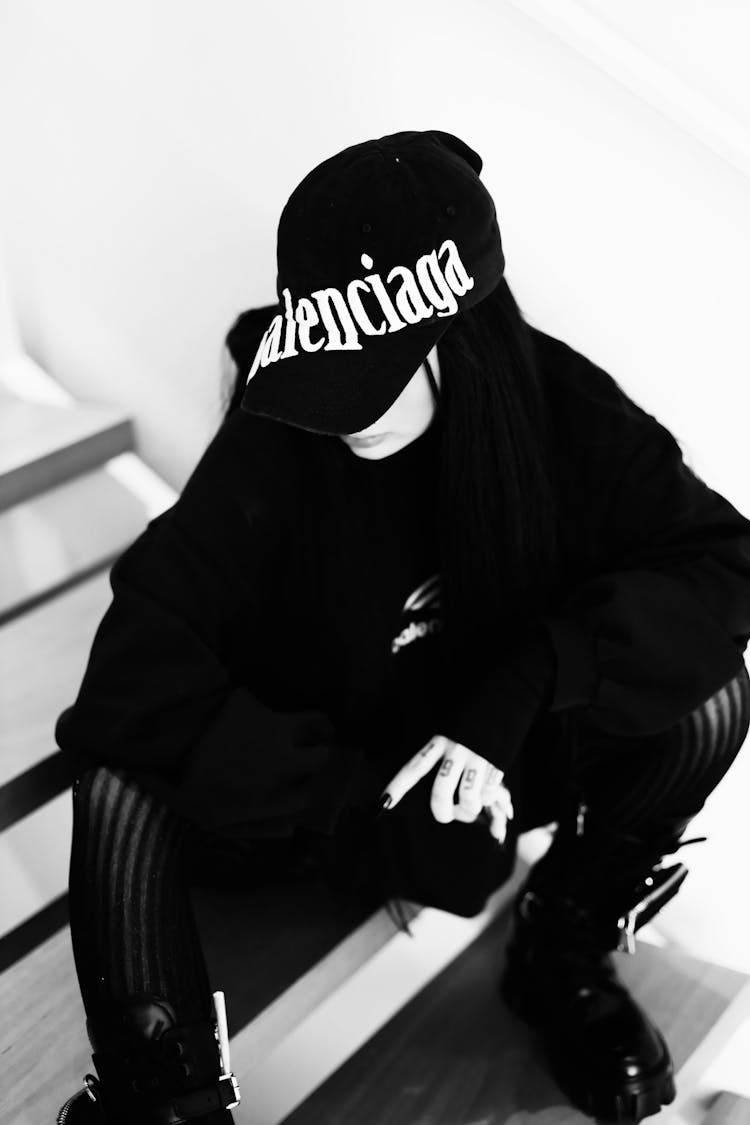 Girl In Black Outfit And Hat Sitting On Stairs