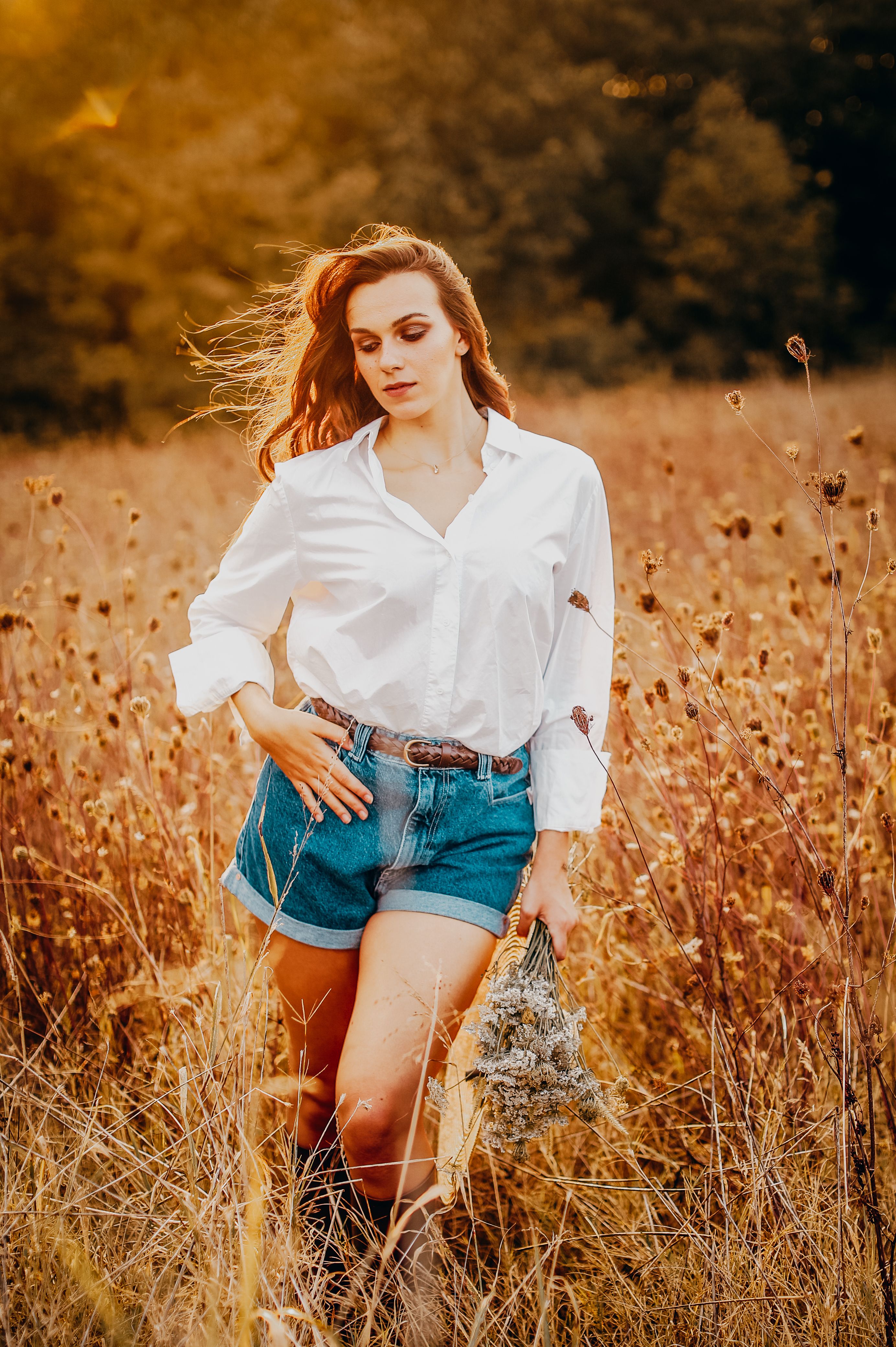 A Woman in White Dress Shirt and Denim Shorts on Brown Grass Field ...