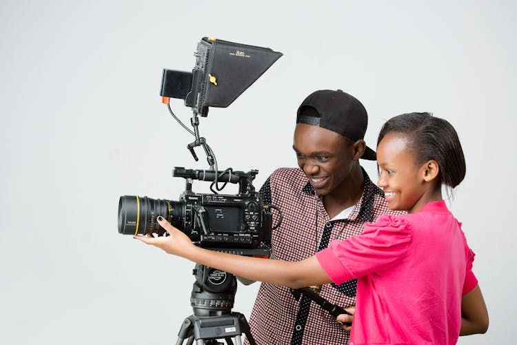 Smiling People Filming With Professional Camera In Studio