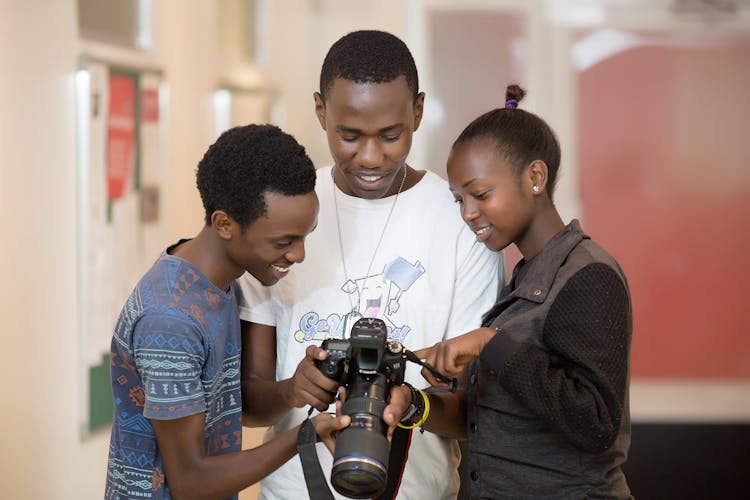 Smiling People Looking At Professional Camera Screen